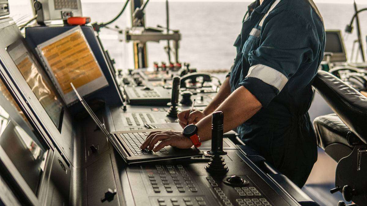 marine_navigational_officer_using_laptop_at_sea_on_the_bridge